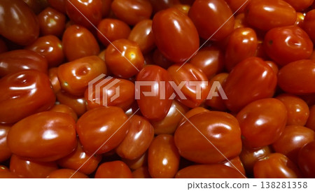 Fresh ripe plum cherry tomatoes close up full frame Fresh ripe plum cherry tomatoes close up full frame 138281358