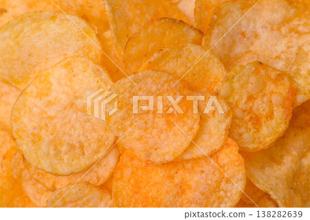 Crispy potato chips, golden slices seasoned with salt and spices. Potato chips 138282639