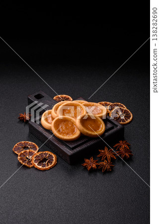 Round mini tartlets with citrus or peach jam and crumbly pastry. Mini citrus tarts Round mini tartlets with citrus or peach jam and crumbly pastry. Mini citrus tarts 138282690