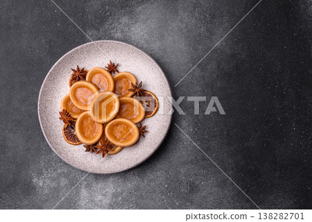 Round mini tartlets with citrus or peach jam and crumbly pastry. Mini citrus tarts Round mini tartlets with citrus or peach jam and crumbly pastry. Mini citrus tarts 138282701