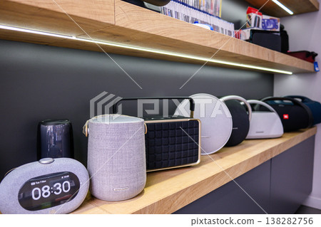 Row of smart home gadgets on a wooden shelf with soft lighting Row of smart home gadgets on a wooden shelf with soft lighting 138282756