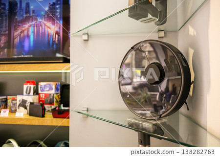Modern Robot vacuum featuring glass shelves and a wall-mounted fan 138282763