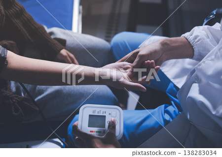 The doctor measures blood pressure to the patient The doctor measures blood pressure to the patient 138283034