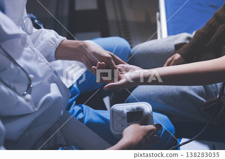The doctor measures blood pressure to the patient The doctor measures blood pressure to the patient 138283035