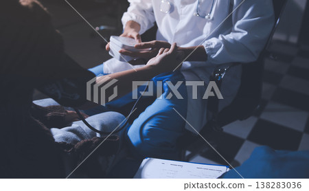 The doctor measures blood pressure to the patient The doctor measures blood pressure to the patient 138283036