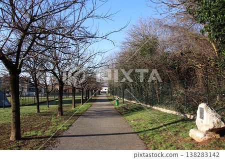 Sunny walking path in a public park in Castenedolo, Brescia, Italy Sunny walking path in a public park in Castenedolo, Brescia, Italy 138283142
