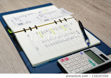 A household budget notebook, receipts, and calculator to help manage rising gasoline prices and protect household finances. A household budget notebook, receipts, and calculator to help manage rising gasoline prices and protect household finances. 138283308