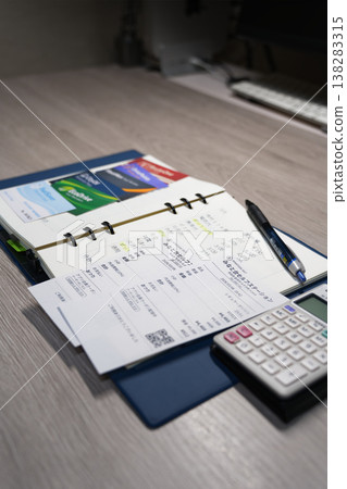 Discount cards, receipts, a household budget book, and a calculator to help cope with rising gasoline prices. 138283315