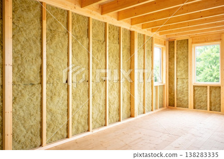 Wooden house interior under construction with thermal insulation panels in walls Wooden house interior under construction with thermal insulation panels in walls 138283335