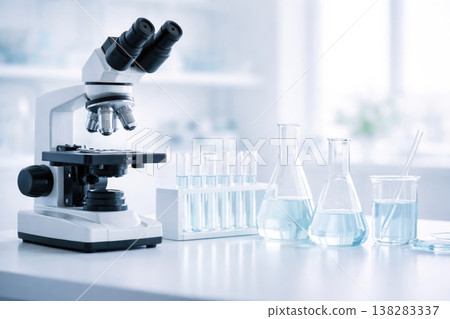 Laboratory microscope with glassware and test tubes in clean scientific environment Laboratory microscope with glassware and test tubes in clean scientific environment 138283337