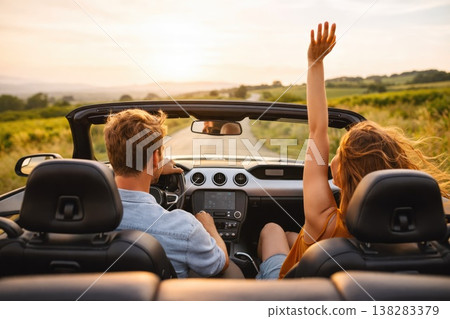 Couple enjoying road trip in convertible car during sunset travel adventure Couple enjoying road trip in convertible car during sunset travel adventure 138283379