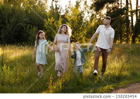 Active Family Moving Along Rural Path During Sunset Emphasizing Health And Fitness Active Family Moving Along Rural Path During Sunset Emphasizing Health And Fitness 138283454