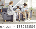 Young mother arguing with her children sitting on sofa addicted from mobile phone. 138283684