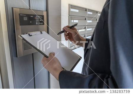 The hands of a worker checking an electric meter during electrical work. The hands of a worker checking an electric meter during electrical work. 138283739