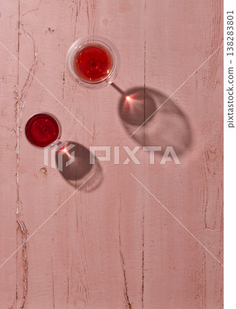 Red wine glasses on pink wooden background, top view 138283801