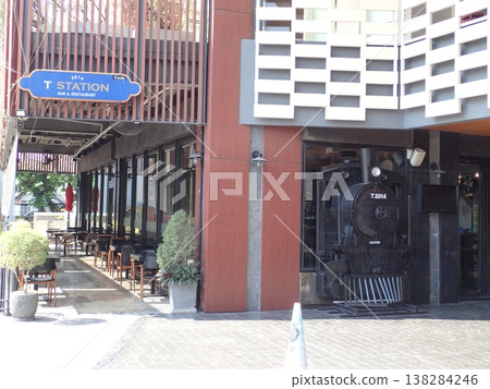 Exterior of a cafe in Thailand; entrance to a restaurant with a retro locomotive; streetscape of commercial facilities. 138284246