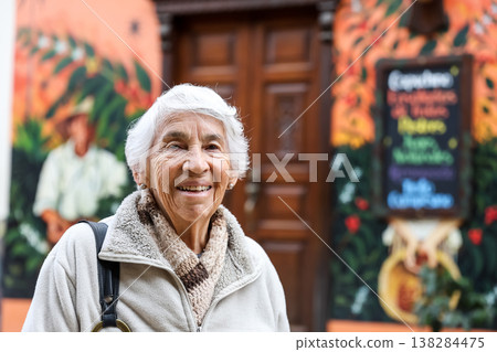 Happy senior lifestyle concept. Senior woman at the central square of the beautiful small town of Raquira. The city of pots in Colombia. 138284475