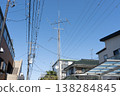 A full-fledged amateur radio antenna towering over a detached house. 138284845