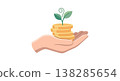 Hand holding stacked gold coins with a small green plant growing on top symbolizing financial growth savings investment 138285654