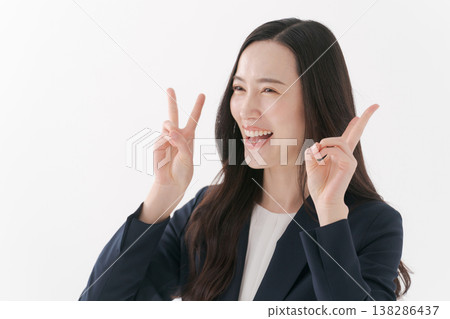 A woman in a suit making a peace sign 138286437