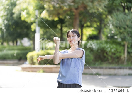 A young woman stretching outdoors A young woman stretching outdoors 138286448
