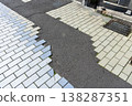 The brick sidewalk has been temporarily repaired with asphalt due to construction work - patched up. 138287351