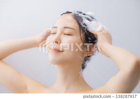 A woman shampooing A woman shampooing 138287917