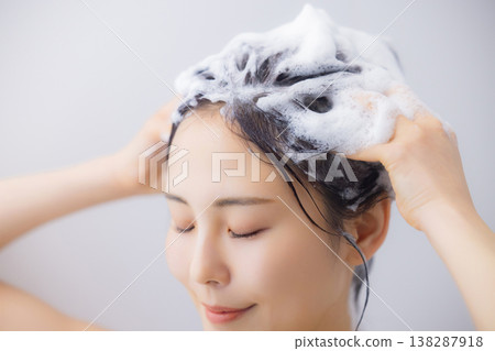 A woman shampooing A woman shampooing 138287918