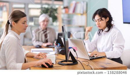 Group of women works on laptop in office Group of women works on laptop in office 138288046