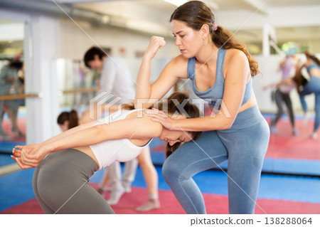 Women in pair perform effective impact on pain points while learning self-defense. Women in pair perform effective impact on pain points while learning self-defense. 138288064