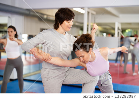 Women in pair perform effective impact on pain points while learning self-defense. Women in pair perform effective impact on pain points while learning self-defense. 138288087