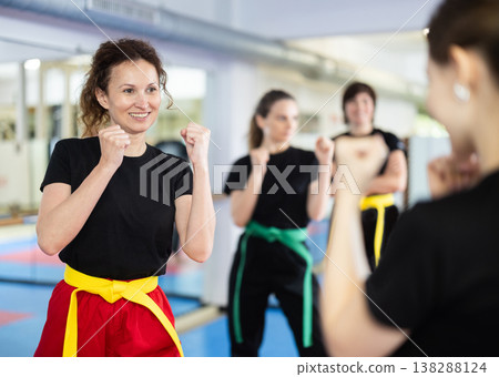 Women practice karate techniques in pairs Women practice karate techniques in pairs 138288124