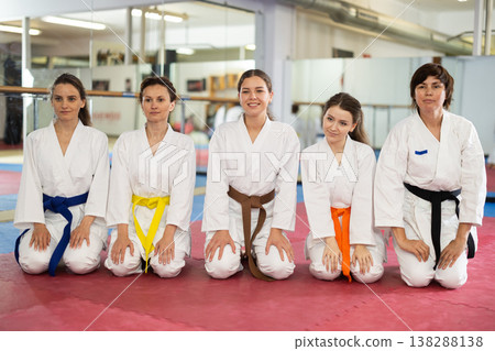 Group of karatekas sitting in pose on floor Group of karatekas sitting in pose on floor 138288138