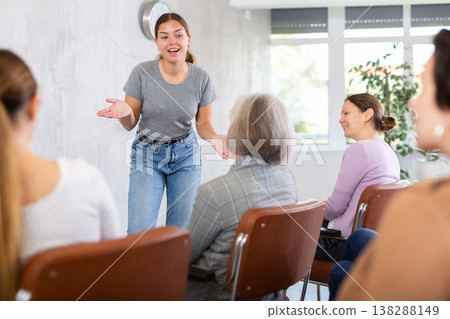 Young female tutor leading educational class for group of women Young female tutor leading educational class for group of women 138288149