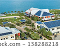 Autonomous buildings in Florida with photovoltaic rooftops covered with solar panels for producing of clean ecological electrical energy in town center 138288218