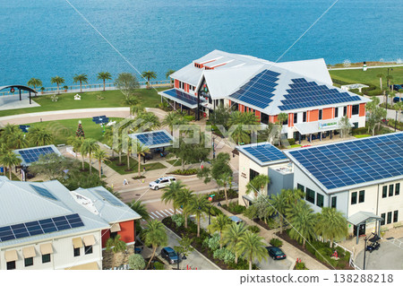 Autonomous buildings in Florida with photovoltaic rooftops covered with solar panels for producing of clean ecological electrical energy in town center 138288218