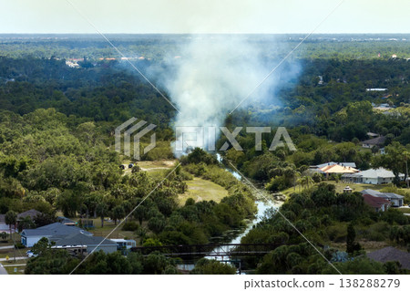 Aerial view of wildfire burning through forest close to suburban homes in Florida Aerial view of wildfire burning through forest close to suburban homes in Florida 138288279