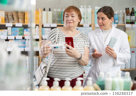 woman using phone and scanning barcode of antifungal ointment 138288317