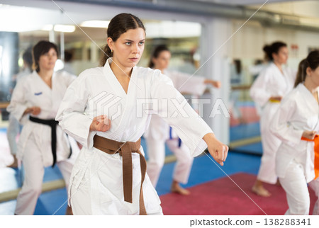 Women in self-defense training in white kimono with belts 138288341