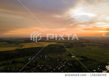 Aerial view of residential houses in suburban rural area at sunset Aerial view of residential houses in suburban rural area at sunset 138288349