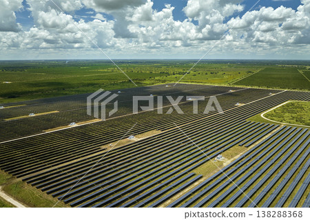 Aerial view of large sustainable electrical power plant with rows of solar photovoltaic panels for producing clean electric energy. Concept of renewable electricity with zero emission 138288368