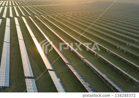 Aerial view of large sustainable electrical power plant with rows of solar photovoltaic panels for producing clean electric energy in evening. Concept of renewable electricity with zero emission 138288372