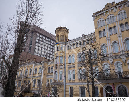 [Ukraine] Historic yellow buildings and winter street trees in the capital Kyiv 138288392