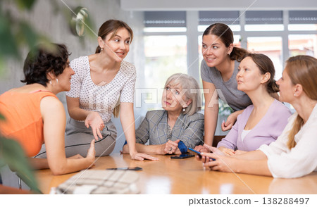 Young woman discussing study topics with female coursemates Young woman discussing study topics with female coursemates 138288497