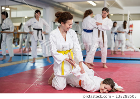 Women pupils train to perform defensive karate installations and attacking combat techniques Women pupils train to perform defensive karate installations and attacking combat techniques 138288503