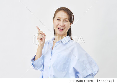 Woman pointing to the left on a white background Woman pointing to the left on a white background 138288541