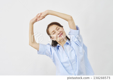 An elderly woman stretching against a white background An elderly woman stretching against a white background 138288573