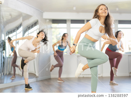 Women perform choreographic exercises energetic dance together. Hip hop in spacious training hall 138288597