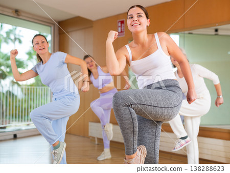 Active young woman practicing aerobic dance in training hall Active young woman practicing aerobic dance in training hall 138288623