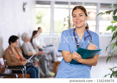 Woman doctor wear white medical uniform and stethoscope with folder of documents 138288678